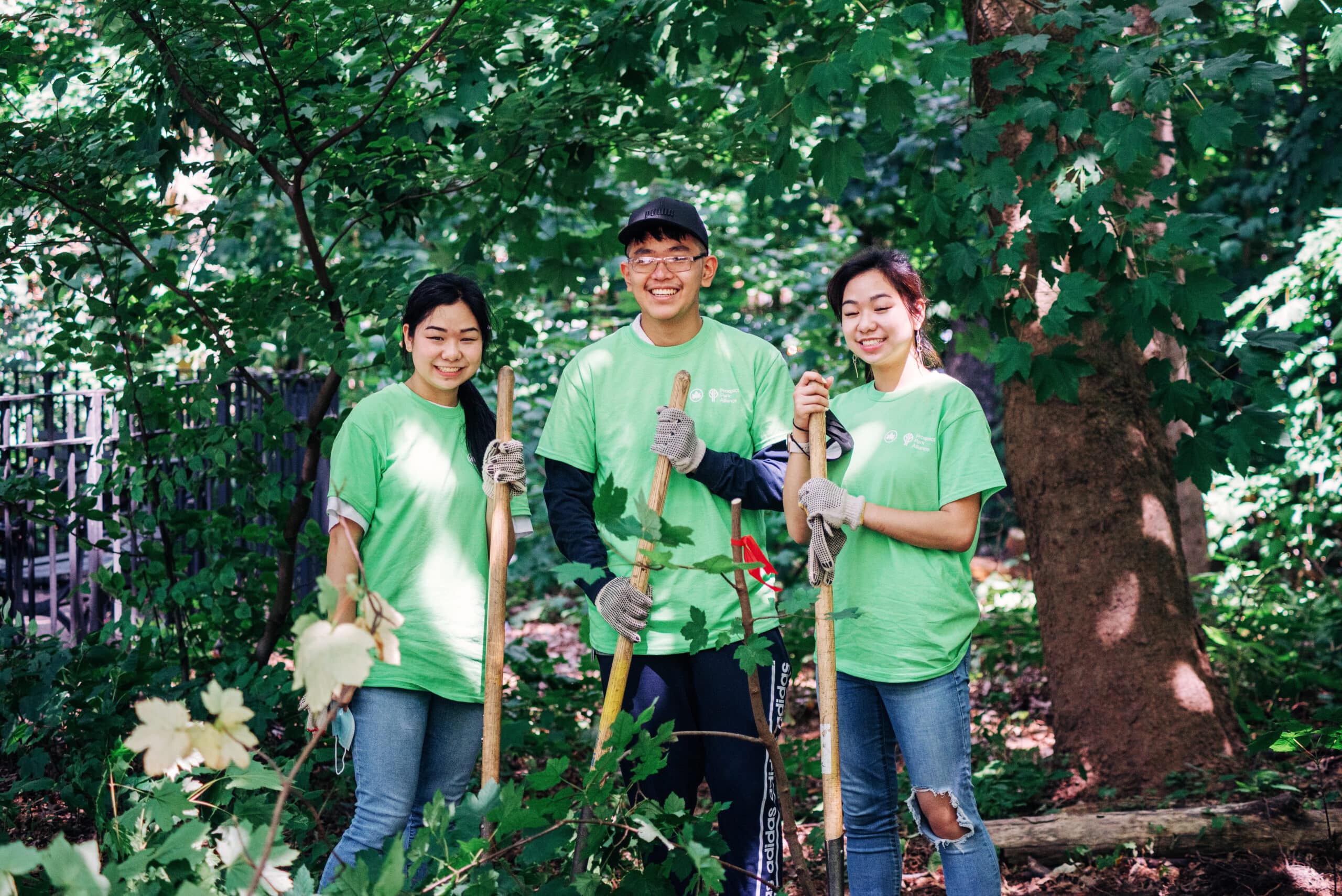 Three Prospect Park Alliance volunteers smiling