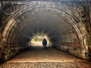 a photo of a person standing under a bridge in Prospect Park