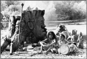 Kids Sitting In Front of Face Structures